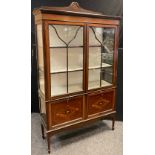An Edwardian mahogany china display cabinet, shaped quarter galleried top, pair of glazed doors