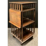 An early 20th century revolving oak bookcase, rectangular top with carved gadroon edge, three
