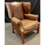 A chesterfield wing-back armchair, in brown leather, by Halo Furniture, Lincoln model, 106cm high