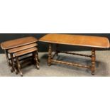 An Ercol nest of three elm tables, the largest 42cm high x 57.5cm x 35cm; an Ercol elm coffee table,