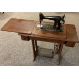An early 20th century Singer treadle sewing machine, number EB924703.