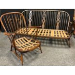 An Ercol three seat sofa, and an Ercol spindle-back single seat armchair, (2).