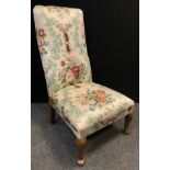 A Victorian nursing chair, upholstered back, upholstered and sprung seat, walnut cabriole fore-legs,