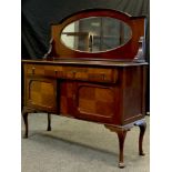 A early 20th century mahogany mirror back sideboard, arched top with bevelled oval mirror, pair of