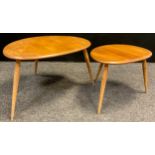 An Ercol ‘Pebble’ model nested pair of ‘Blonde’ Elm side tables, the largest measuring 39.5cm high x