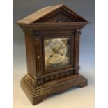An early 20th century Junghans mantle clock, eight-day movement, oak case, architectural pediment,