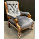 A Victorian walnut fireside armchair, button-back, sprung seat, turned legs, ceramic casters, 87.5cm