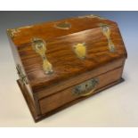 An early 20th century oak desk top writing box, pierced brass strap hinges and decoration, single