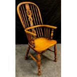 An early 19th century style high-back Windsor chair, pierced splat, shaped seat, turned legs, H-