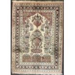 A Persian Kashan silk carpet / rug, knotted with a central field as a stylised floral arbor and