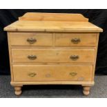 An Edwardian pine chest of drawers, quarter galleried top, two short over two graduated long