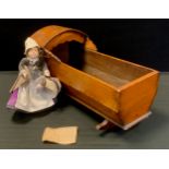 An early 20th century stained babies cradle, rocking feet, 28cm high, 48.5cm long, 22cm wide, with