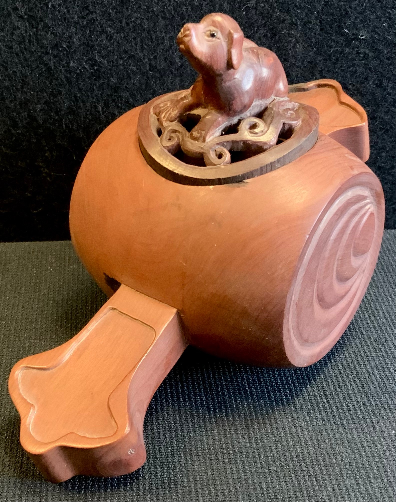 A carved wooden insect box, dog top, signed