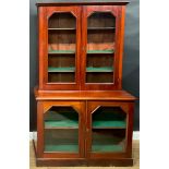 A late 19th/early 20th century mahogany library bookcase, moulded cornice above a pair of glazed
