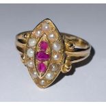 A 19th century 18ct gold ring, the lozenge shaped mount set with three rubies, surrounded by seed