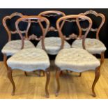 A set of three Victorian rosewood balloon back dining chairs, 85cm high, 46cm wide, the seat 35cm