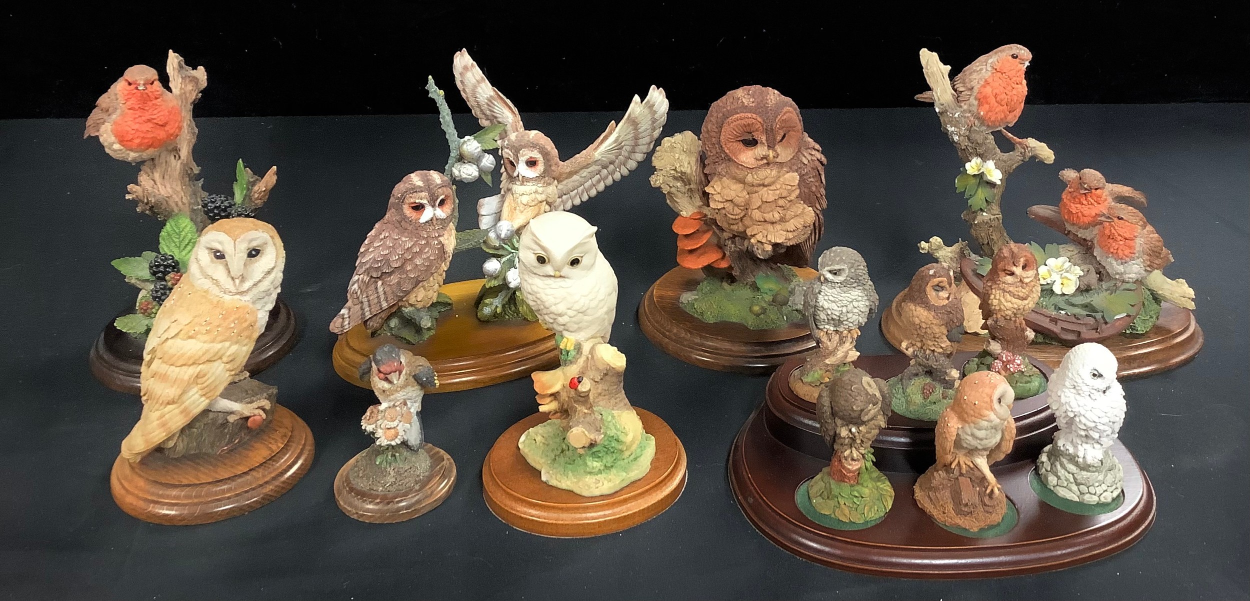 A set of six Royal Doulton miniature models of owls, each 8cm, wooden stand; a Country Artists resin