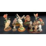 A set of six Royal Doulton miniature models of owls, each 8cm, wooden stand; a Country Artists resin