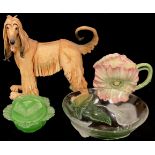 A novelty teapot as a flower, 18cm; a resin model of a hound, 34cm; a green glass dish and cover,