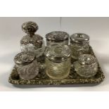 An Edwardian silver mounted clear glass globular scent bottle, hobnail cut, pierced silver mount and