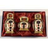 A Royal Crown Derby Imari 1128 pattern three piece cruet set, salt, pepper and mustard pots, first