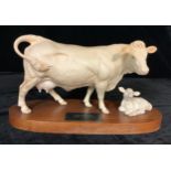 A Beswick Connoisseur model, Charolais Cow and Calf, oval mahogany stand, 33cm