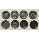 An unusual set of eight George III 18th/19th century pewter shaped circular counter dishes, 9cm in