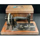 An early 20th century manual sewing machine, inlaid with abalone shell, transfer printed with