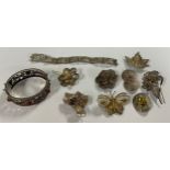 A silver filigree bangle, assorted silver filigree brooches, butterfly, flowers, etc; a similar