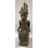 A Benin bronze figure, notable with crown and neck ring, seated upon a throne, 49cm