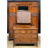 An oak two-piece bedroom suite, comprising wardrobe and dressing chest, the wardrobe with central