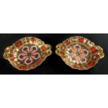 A pair of Royal Crown Derby Imari 1128 pattern two handled pedestal bon-bon dishes, solid gold band,