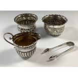 A Victorian silver stop fluted cream jug, 6.5cm, Birmingham 1888, 43g; two silver sugar bowls, a