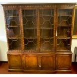 A reproduction breakfront mahogany bookcase, by Reprodux Furniture, 213.5cm high, 204.5cm wide, 37cm