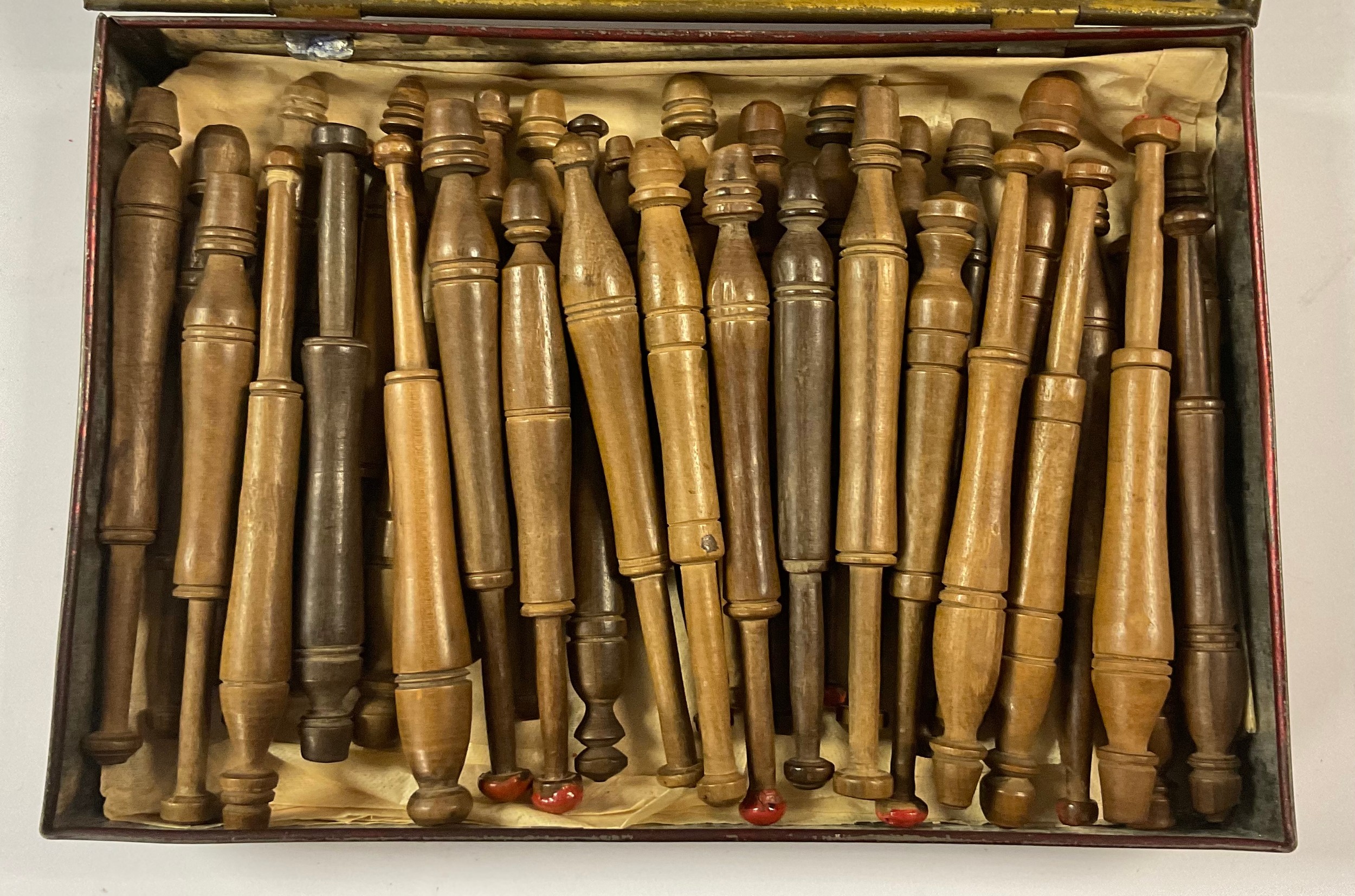A collection of late 19th/early 20th century turned treen lace makers' bobbins, in a Pascall