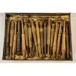 A collection of late 19th/early 20th century turned treen lace makers' bobbins, in a Pascall