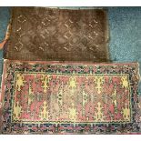 A Middle Eastern woollen rug or carpet, stylised motifs in shades of red, blue and ochre, 183cm x