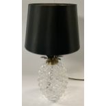 A novelty clear glass table lamp in the form of a pineapple, black shade, 46cm high overall