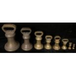 A collection of eight Victorian graduated brass bell weights, the largest 14lbs