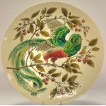 A late 19th century continental circular wall charger, impressed in low relief with a fanciful
