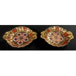 A pair of Royal Crown Derby Imari 1128 pattern two handled pedestal bon-bon dishes, solid gold band,