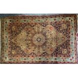 A Middle Eastern woollen rug or carpet, stylised floral decoration in shades of red, blue green