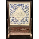 A contemporary Chinese blue and white ceramic table screen, carved hardwood frame and stand, 78cm