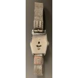 An Art Deco 1920/30s jump hour wristwatch, elongated hexagonal shaped silver coloured metal case,