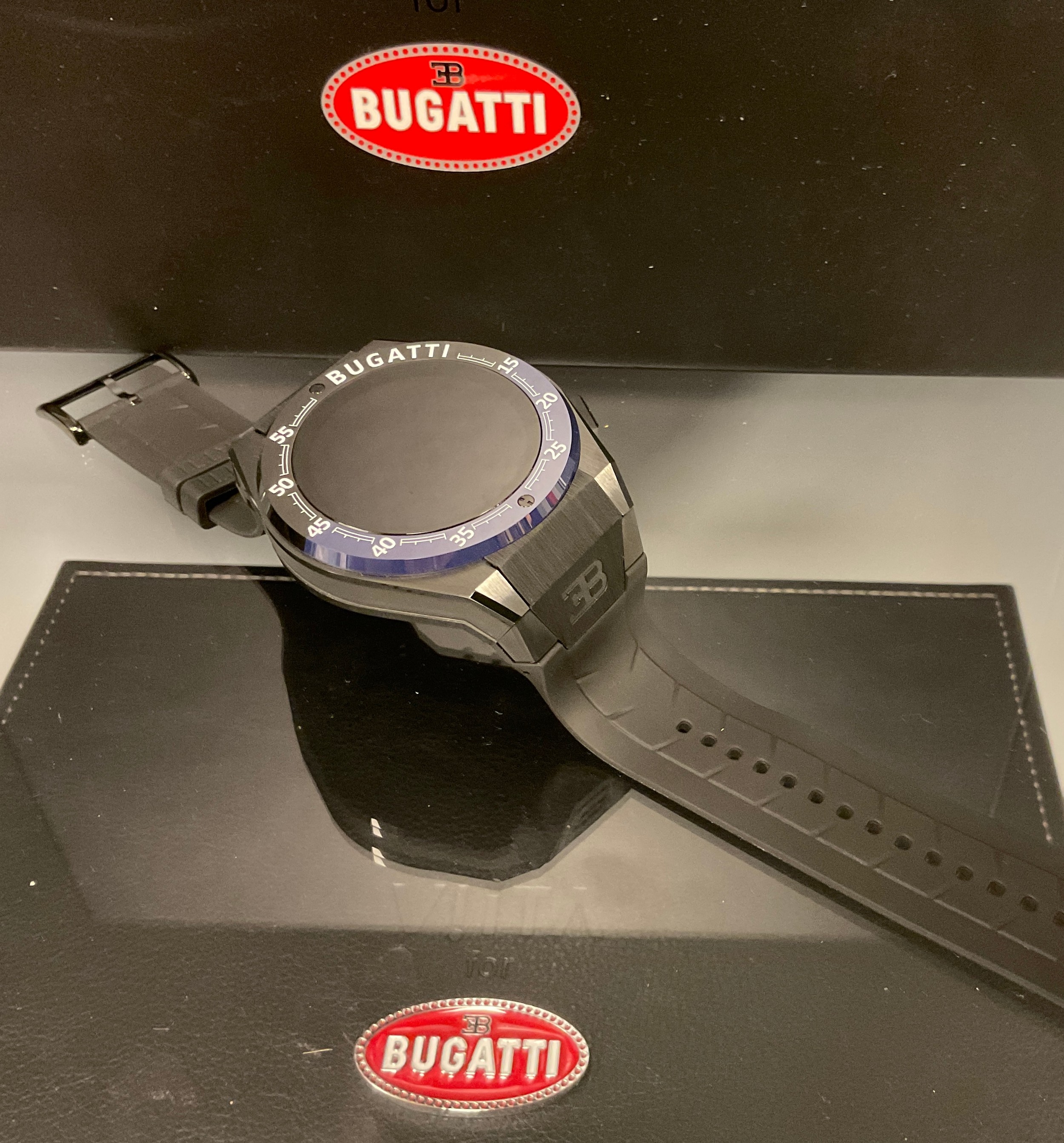 A Bugatti Ceramique edition one smartwatch, three interchangeable bezels, metal and rubber straps,
