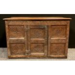 An 18th century oak food cupboard, (later over-sailing top) above a carved six panel front, single