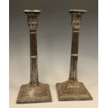 A pair of late 19th century George III style silver plate candlestick, neoclassical stacked