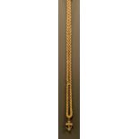 A fancy link 9ct gold guard or muff chain, 168cm long, stamped 9ct, 44.8g, suspending a gilt metal