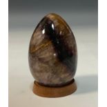 A Derbyshire Blue John egg shaped paperweight, deep colour tones of purple , blue and brown,7cm long
