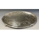 An Edwardian silver oval tray, pierced and cast rim surrounding a central panel festooned with